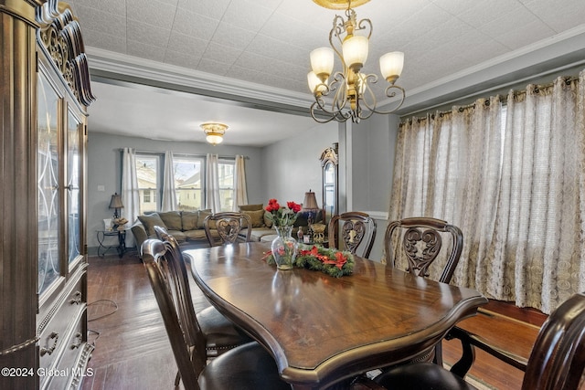 dining room with ornamental molding, dark wood-type flooring, and a notable chandelier