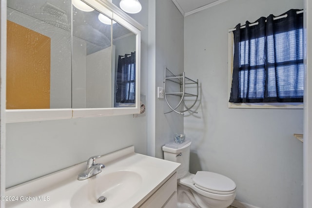 bathroom featuring vanity, toilet, and crown molding