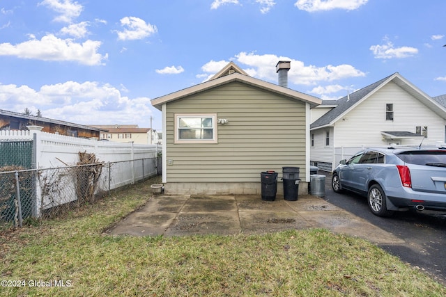 back of property featuring a lawn