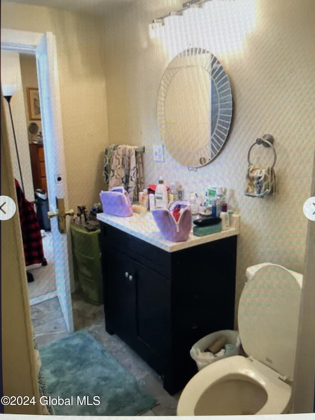 bathroom featuring vanity and toilet