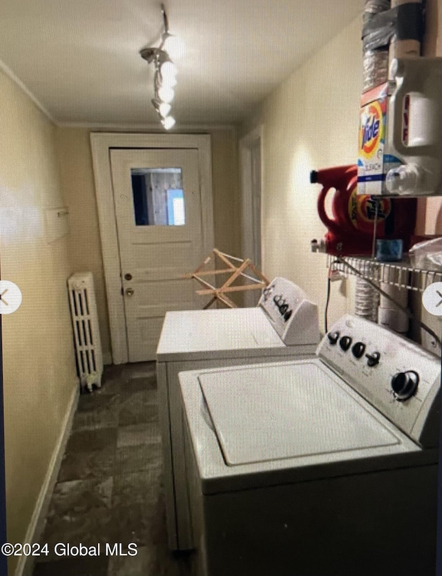 laundry area with independent washer and dryer and radiator