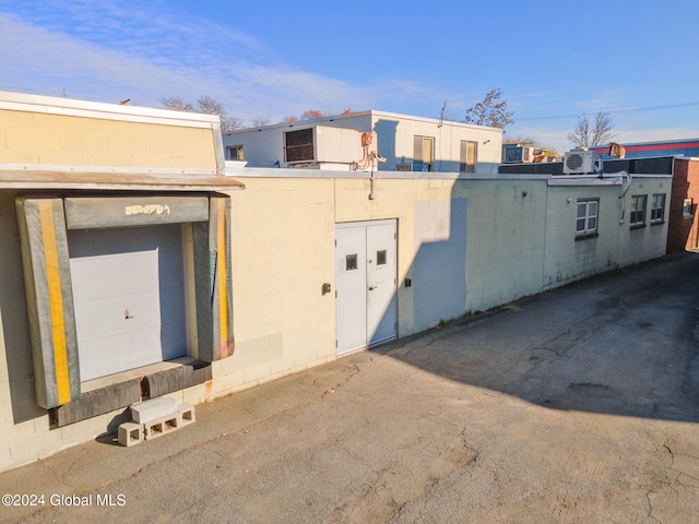 exterior space featuring a garage and cooling unit