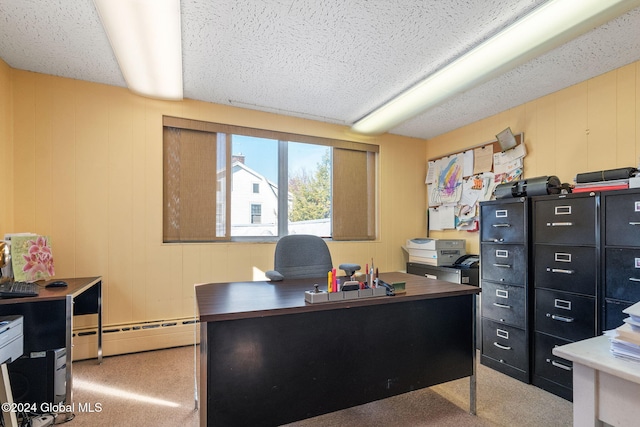 carpeted office with a textured ceiling, wooden walls, and a baseboard heating unit