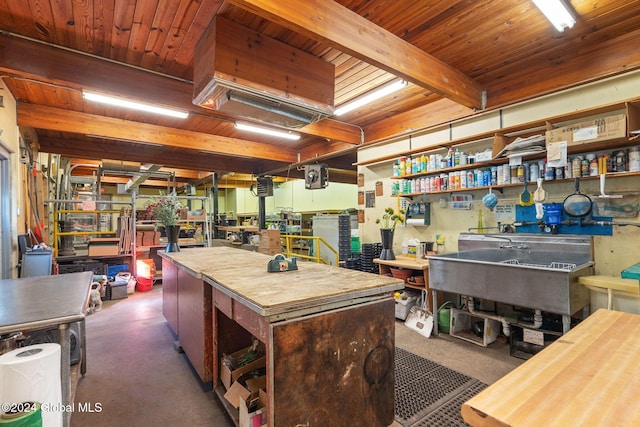 miscellaneous room featuring a workshop area, beamed ceiling, and wooden ceiling