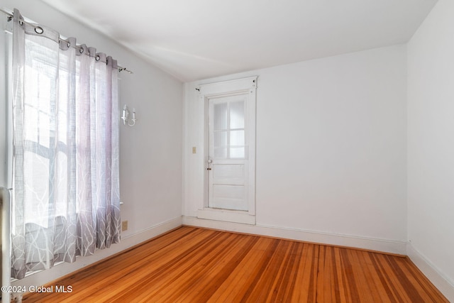 spare room with hardwood / wood-style floors