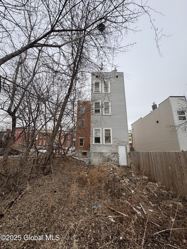 back of house with fence