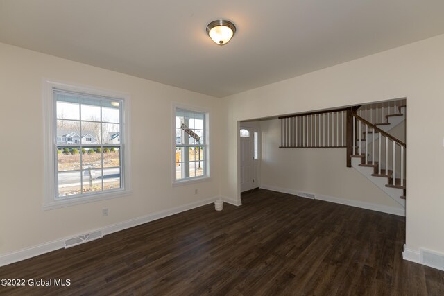 unfurnished living room featuring dark hardwood / wood-style flooring