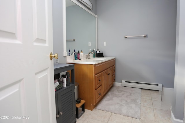 bathroom with tile patterned flooring, vanity, and baseboard heating