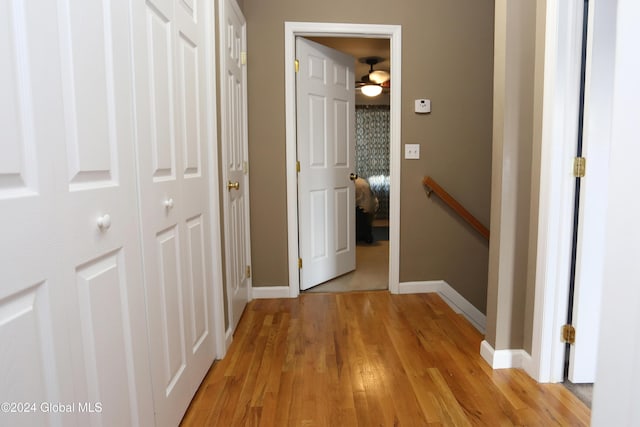 hallway with light hardwood / wood-style flooring