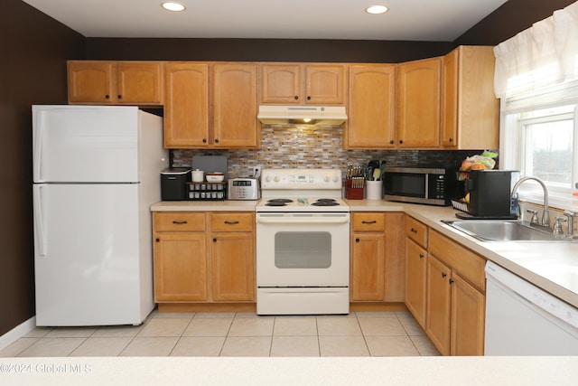 kitchen with light tile patterned flooring, decorative backsplash, white appliances, and sink