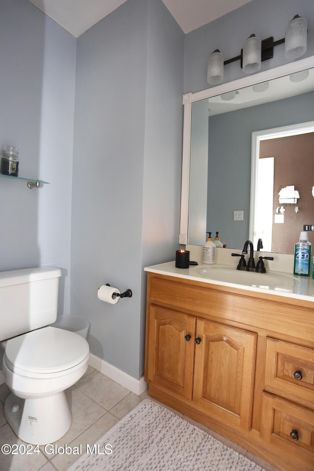 bathroom featuring tile patterned flooring, vanity, and toilet