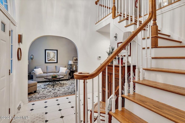 stairway featuring a high ceiling