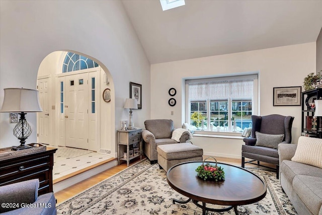 living room with hardwood / wood-style flooring and high vaulted ceiling