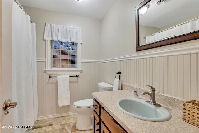 bathroom featuring vanity and toilet