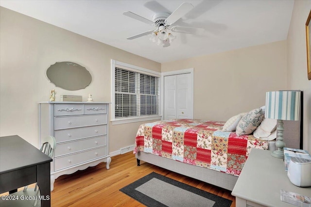 bedroom with a closet, ceiling fan, and hardwood / wood-style floors