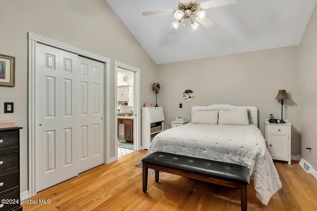 bedroom with ceiling fan, a closet, vaulted ceiling, and light wood-type flooring