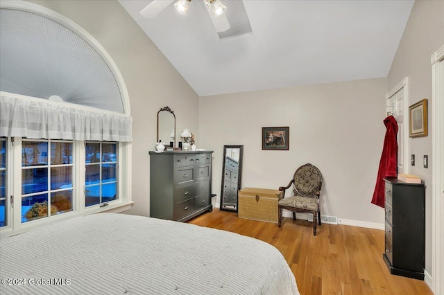 bedroom with ceiling fan, light hardwood / wood-style flooring, and lofted ceiling