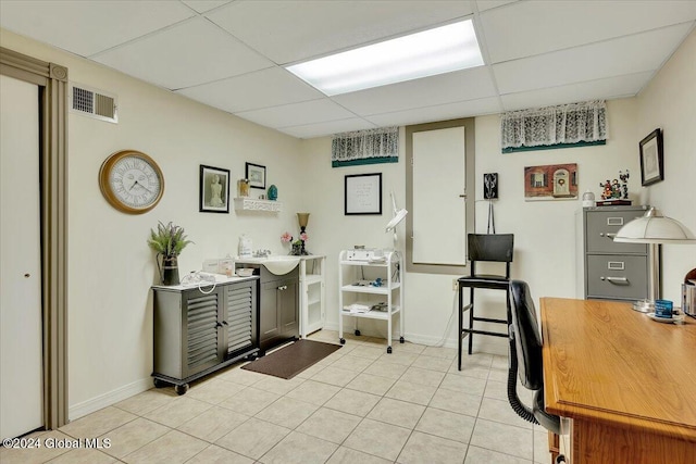 tiled home office with a drop ceiling