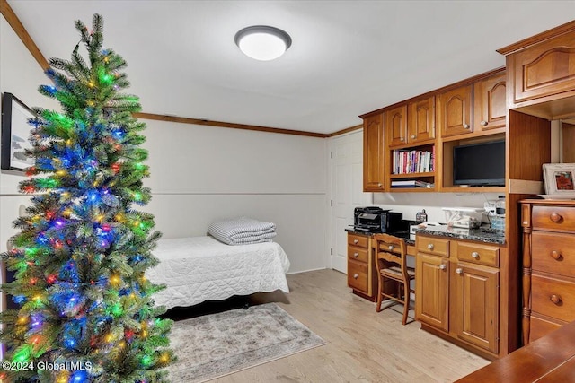 bedroom with crown molding and light hardwood / wood-style flooring