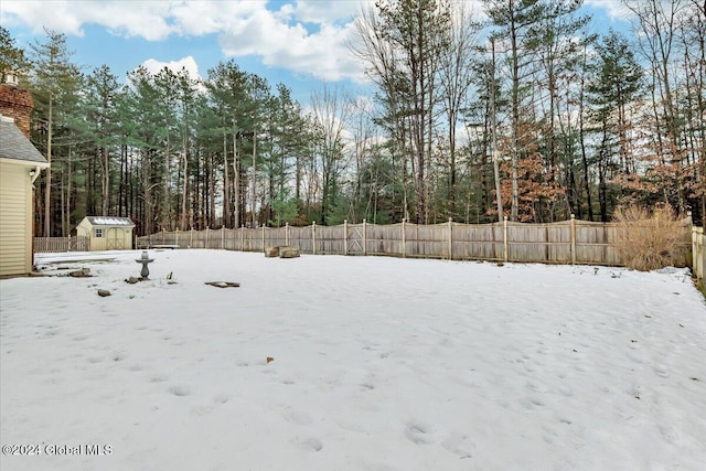 snowy yard with a shed