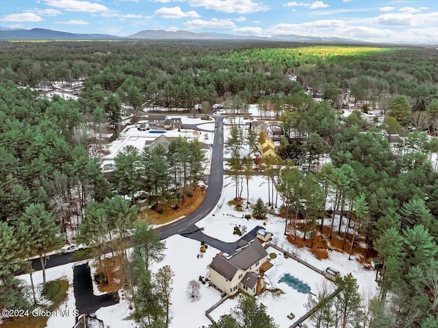 snowy aerial view featuring a mountain view