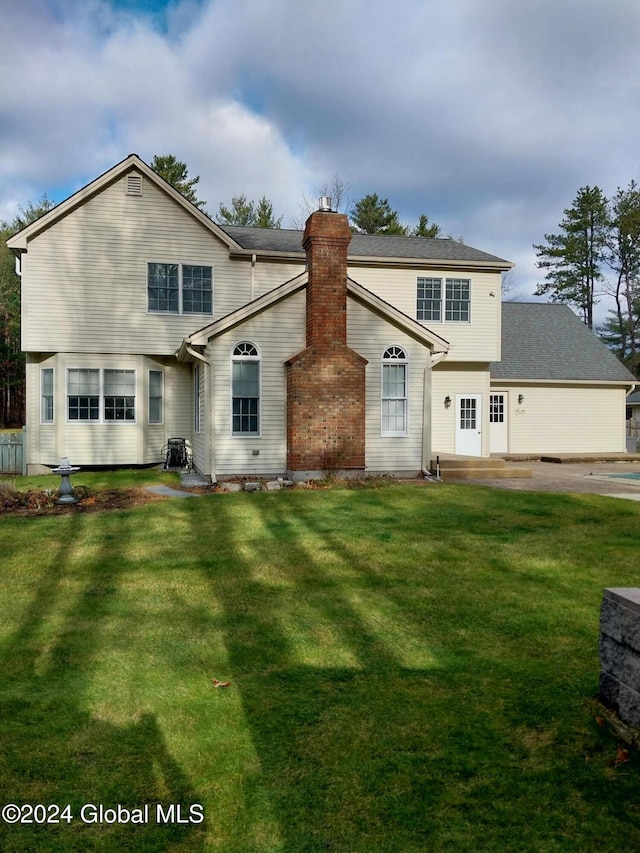 back of house with a yard