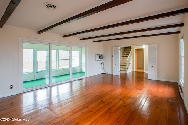 spare room with beamed ceiling and hardwood / wood-style floors