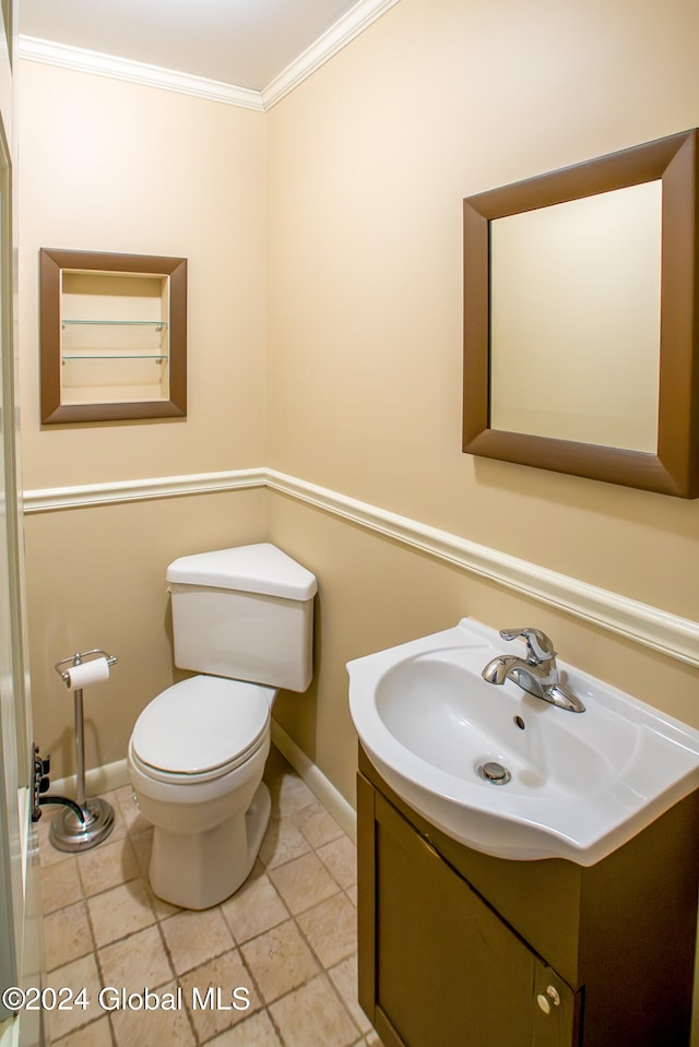 bathroom with crown molding, vanity, and toilet