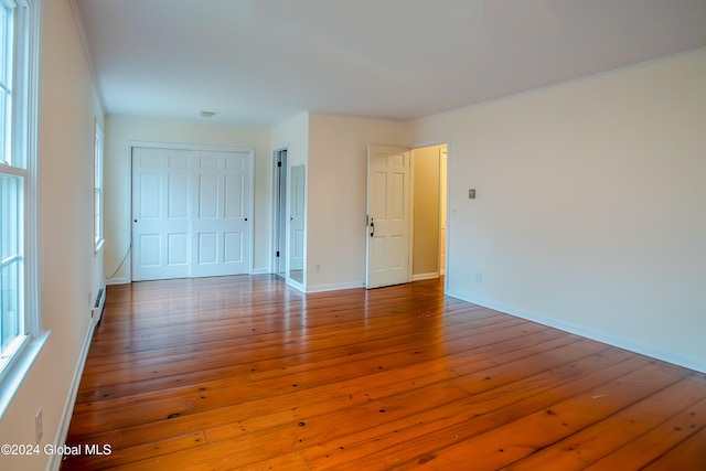 spare room with wood-type flooring