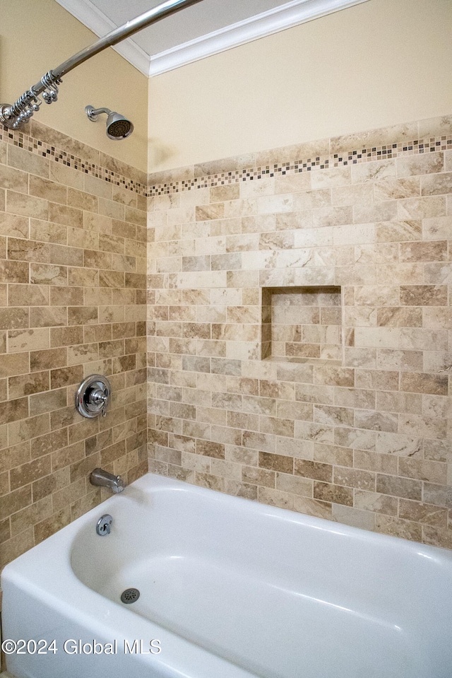 bathroom with tiled shower / bath and ornamental molding