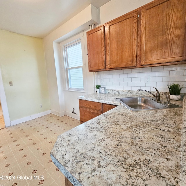 kitchen featuring backsplash and sink