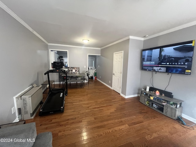 exercise area featuring dark hardwood / wood-style floors and crown molding