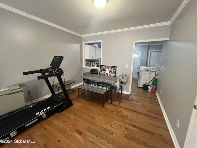 workout room with hardwood / wood-style floors and ornamental molding