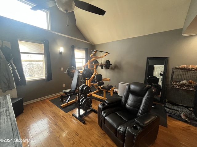 exercise room with light wood-type flooring, high vaulted ceiling, and ceiling fan