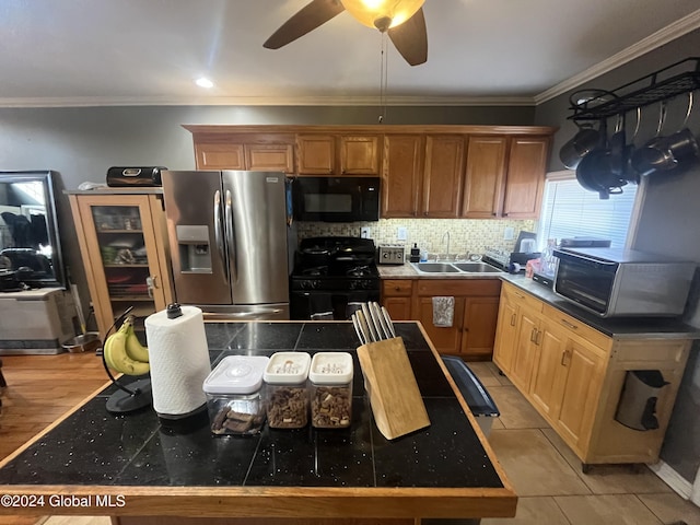 kitchen with ceiling fan, sink, crown molding, light tile patterned floors, and black appliances