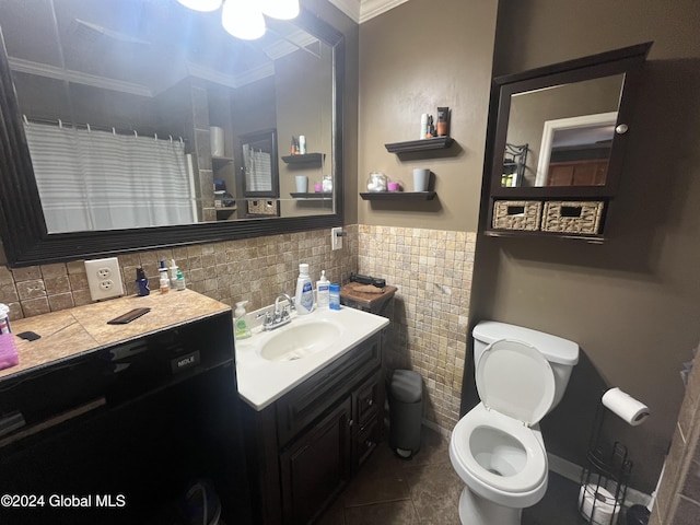 bathroom featuring toilet, vanity, tile patterned floors, and crown molding