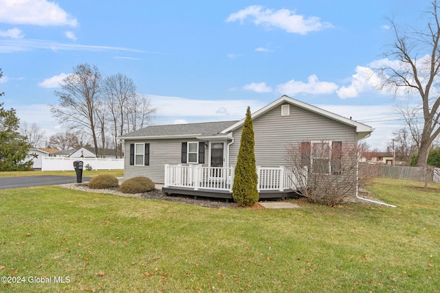 exterior space featuring a deck and a front lawn