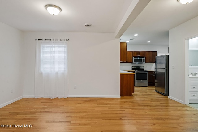 kitchen featuring light hardwood / wood-style floors and appliances with stainless steel finishes