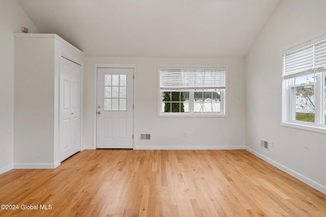 foyer entrance featuring light hardwood / wood-style floors and lofted ceiling