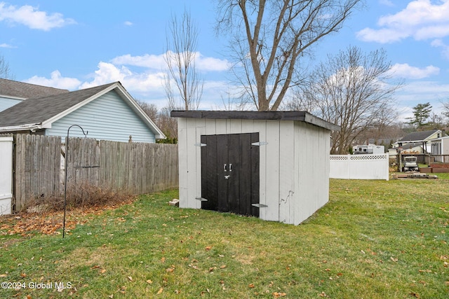 view of outdoor structure with a lawn