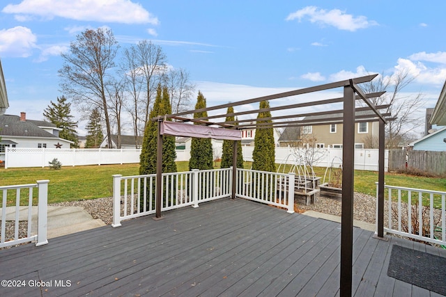 deck featuring a pergola and a lawn