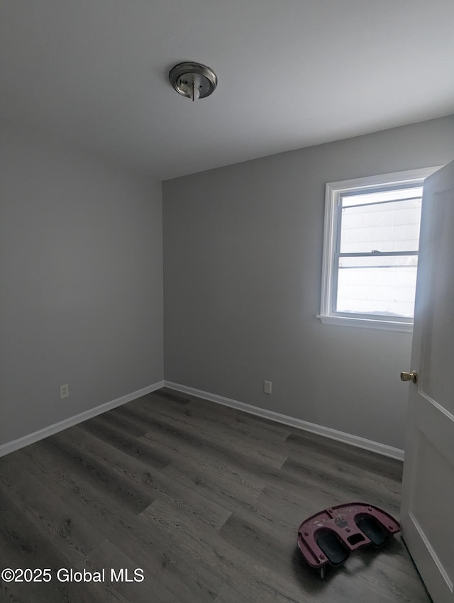 empty room with dark hardwood / wood-style flooring