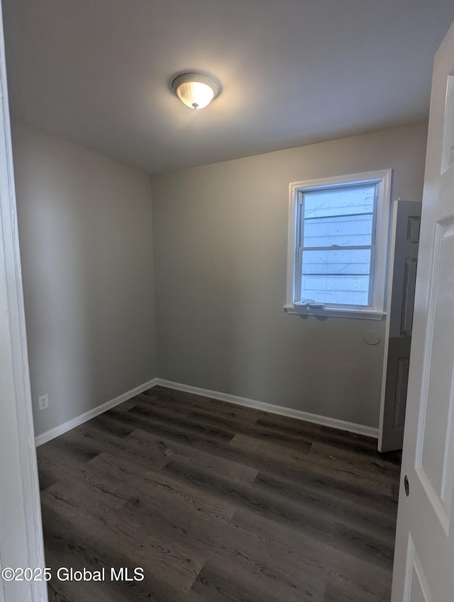 unfurnished room featuring dark hardwood / wood-style flooring