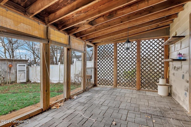 unfurnished sunroom with vaulted ceiling