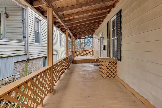 wooden terrace featuring covered porch