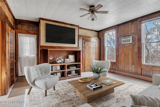 living room featuring a baseboard radiator, ceiling fan, and wood walls