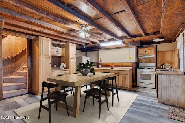 dining space with beamed ceiling, light hardwood / wood-style flooring, ceiling fan, and sink