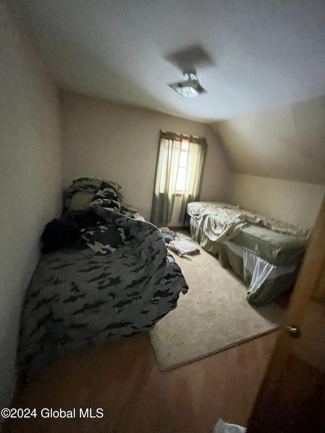 carpeted bedroom with vaulted ceiling