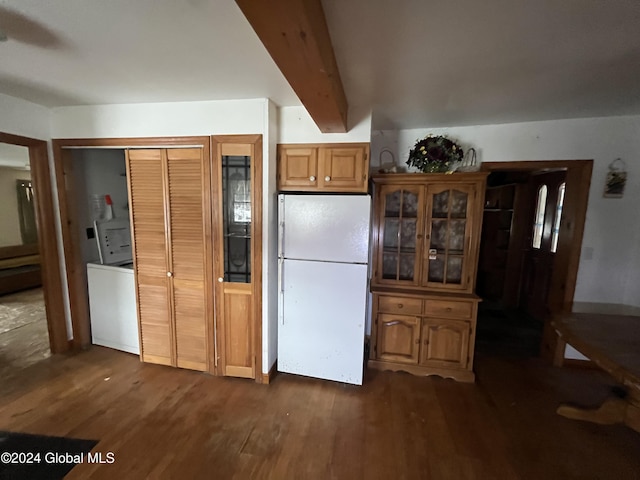 kitchen featuring beamed ceiling, white refrigerator, and dark hardwood / wood-style flooring