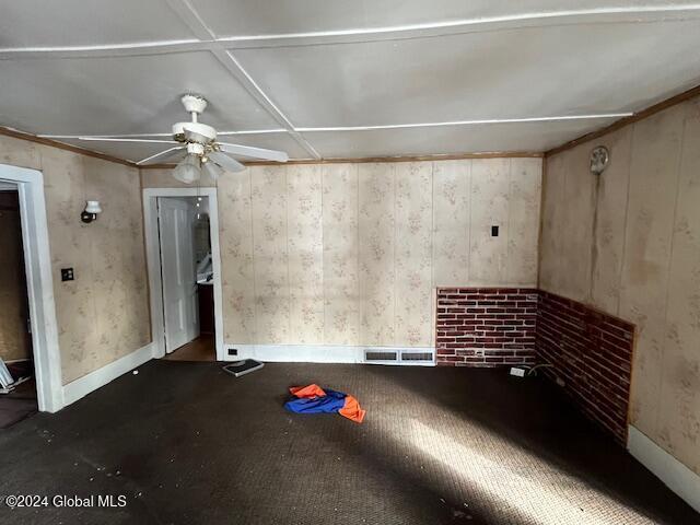 unfurnished room with ceiling fan and coffered ceiling